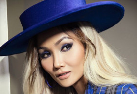 Hoa hậu H’Hen Niê cá tính với nón rộng vành, tone xanh nổi bật